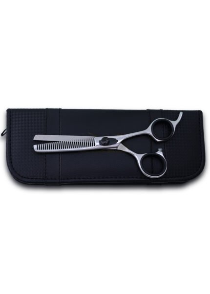 Close-up of razor-edge teeth and adjustable screw on hair thinning shear.